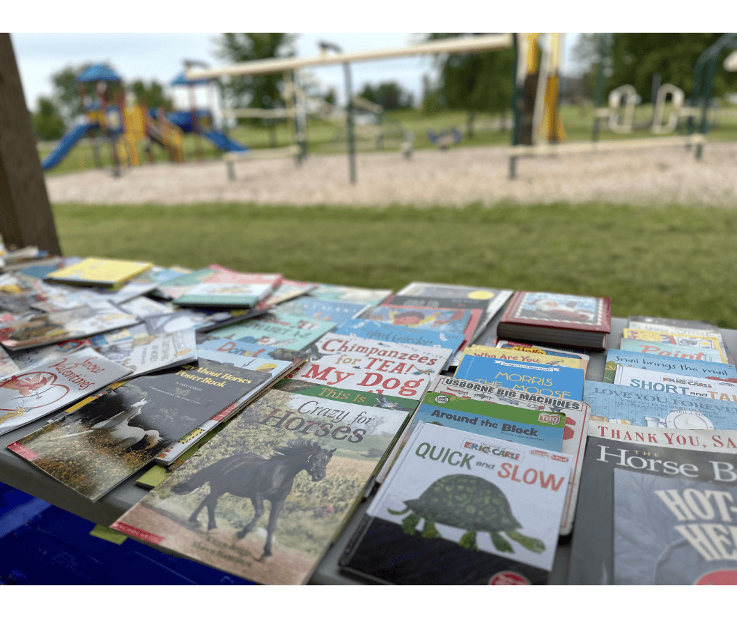 books on a table near a playground