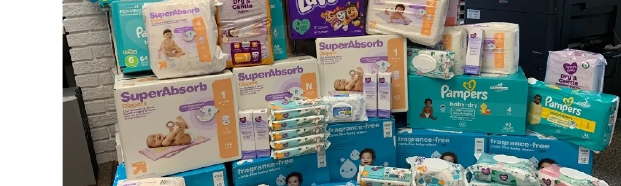 Pile of diapers, wet wipes, and baby cream